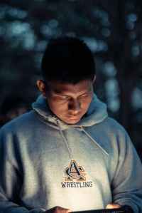 man looking down while using smartphone